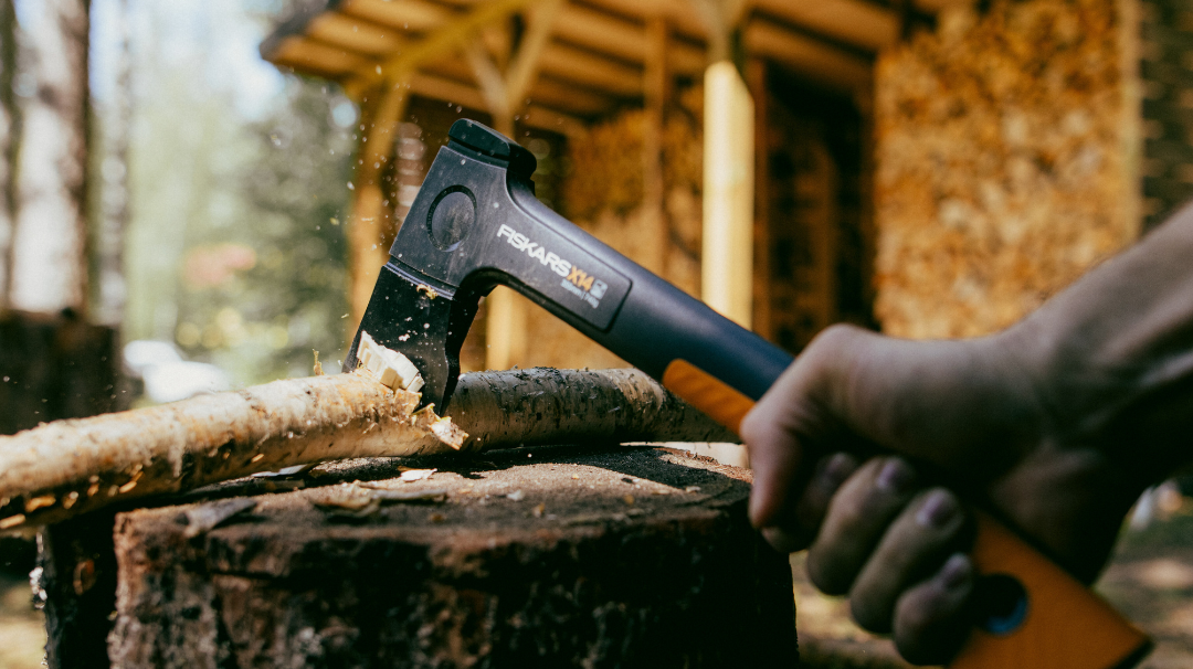 Fiskars wood chopping axe on a log – compact firewood axe for precision cutting”