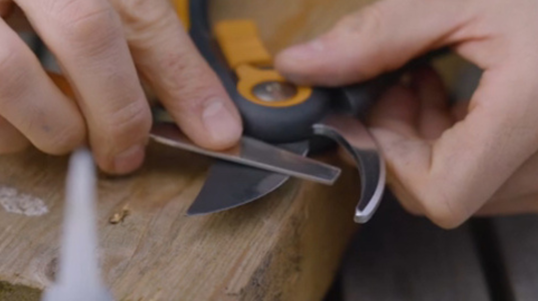Sharpening Fiskars pruning shears with a file to keep garden tools sharp and well maintained
