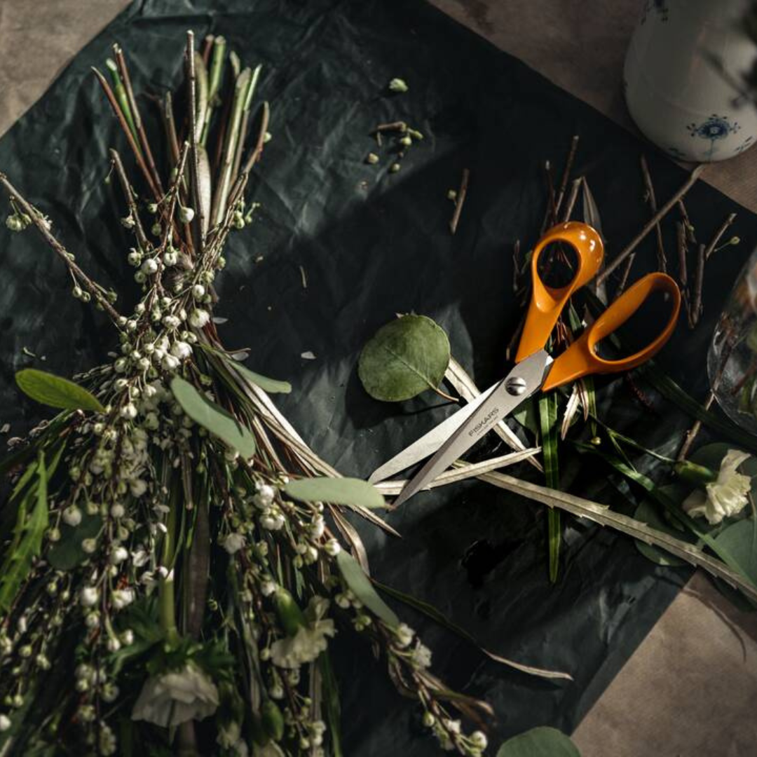Fiskars orange handle scissors next to cut stems