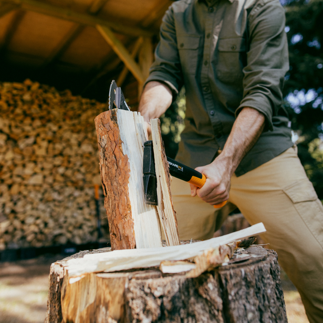 Person chopping wood with an axe in a rustic setting