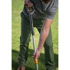 Person using a garden tool on grass